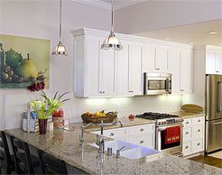 Remodeled white kitchen with pendant lighting