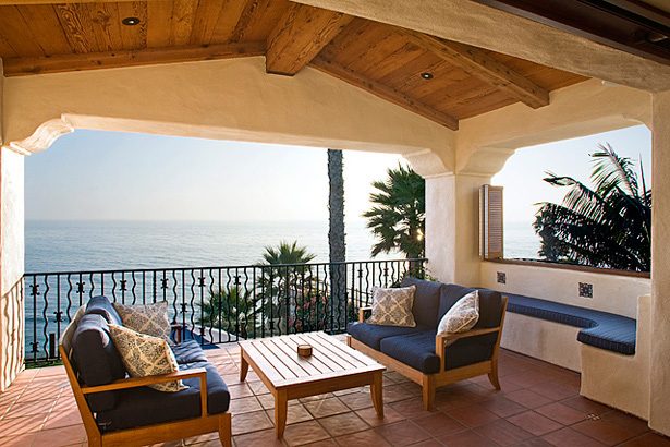 Ocean-view covered patio with iron railing